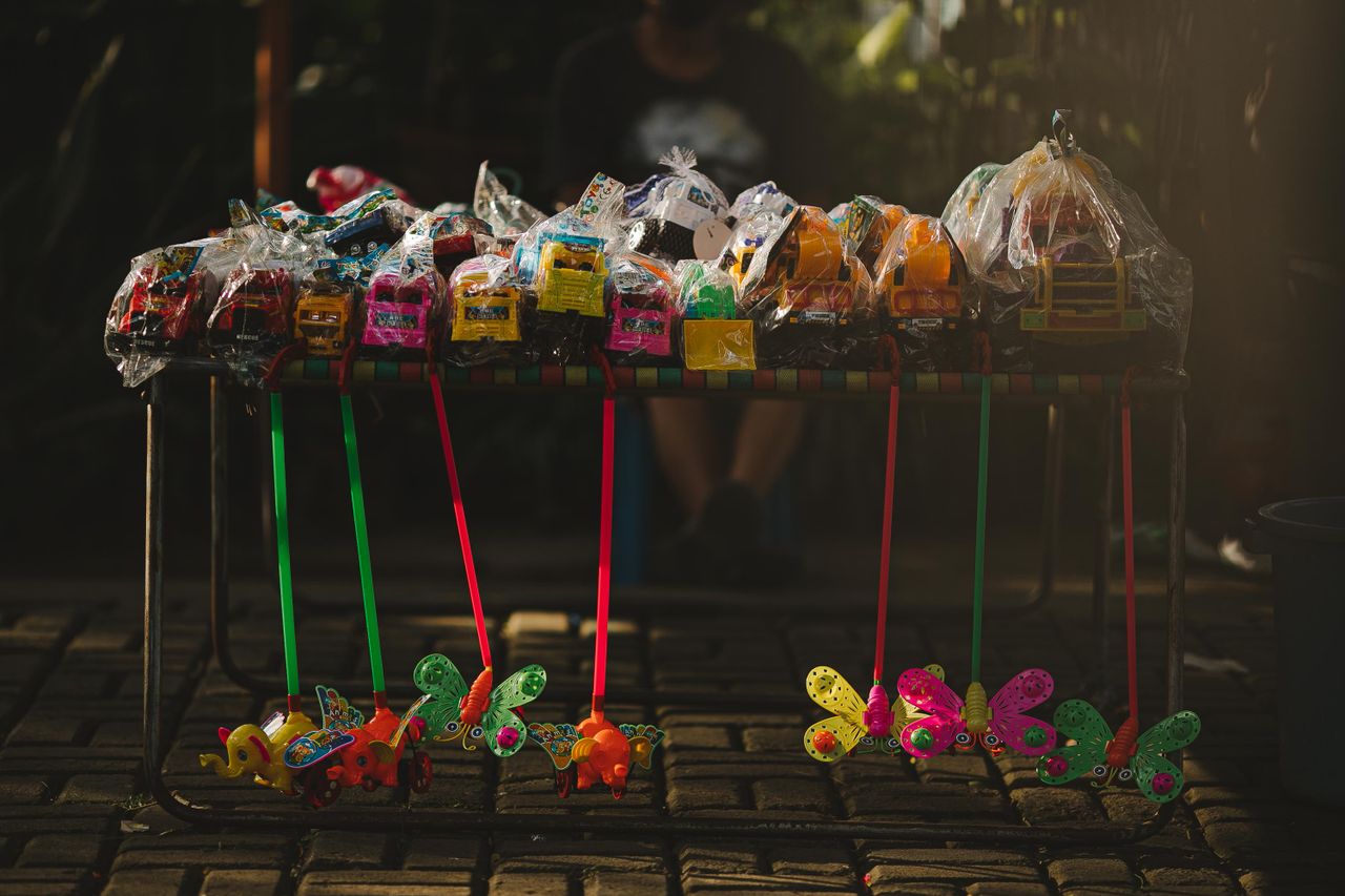 Crafting Captivating Headlines: Your awesome post title goes here A vibrant street display of various colorful toys packaged and arranged on a market stall.