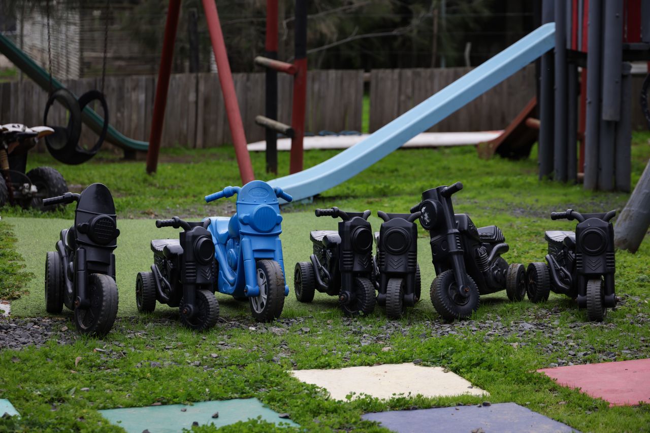 journey Outdoor play area featuring toy motorcycles and a slide, perfect for kids' activities.